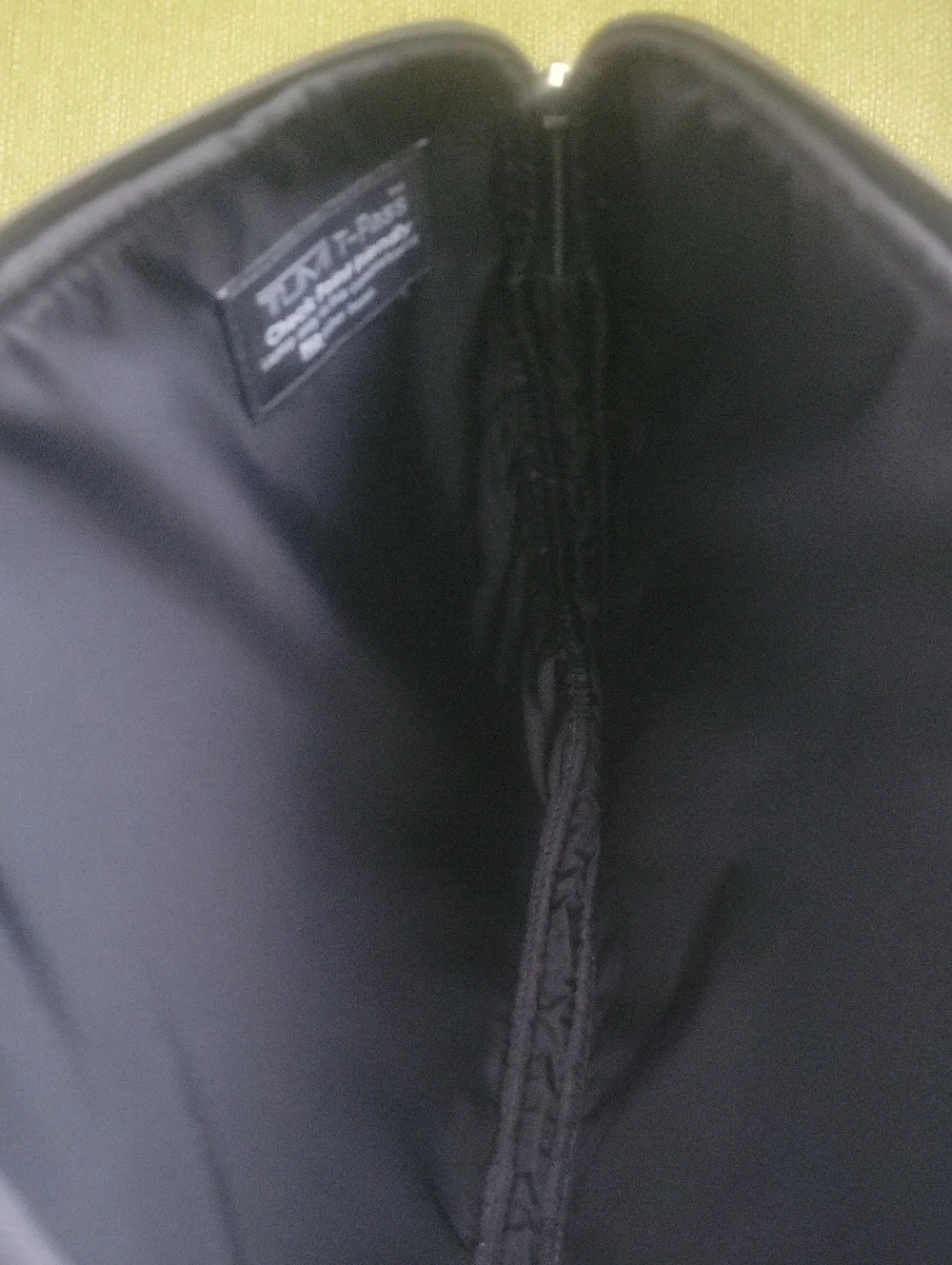 Tumi Black Sleeve with Beige Logo Patch